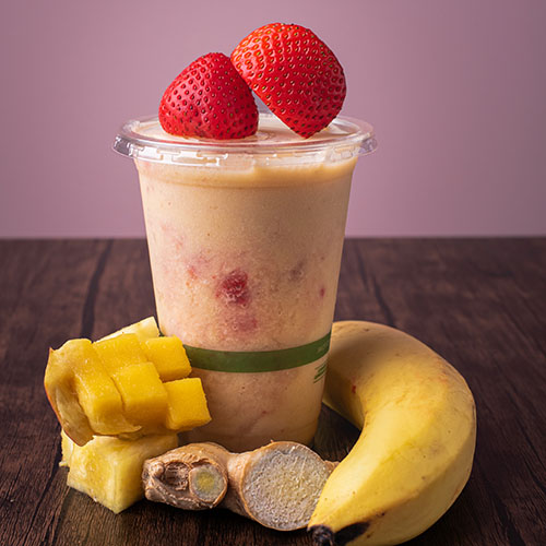yellow colored smoothie with bursts of red