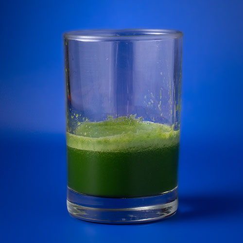 dark green juice with a little light green froth
